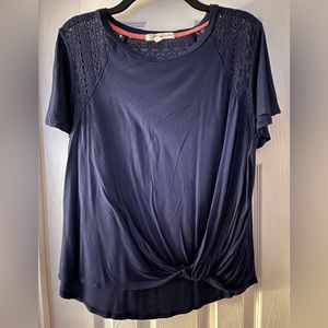 Dark blue short sleeve top with twist front and crochet detail